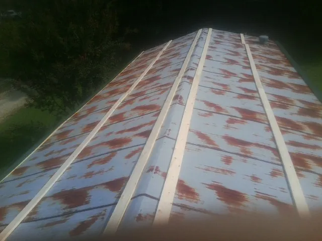 Rusted metal roof panels with new wood purlins before replacement — Storm Damage Roof Repair in New Kent by Roofing Brothers