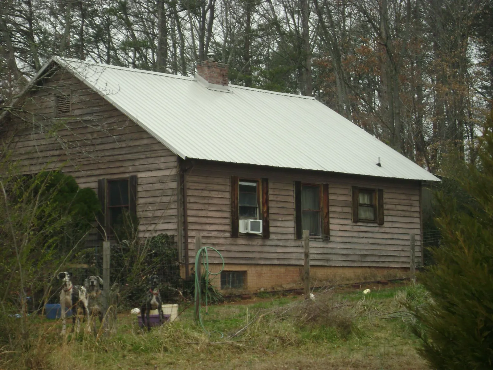 White metal roof on an old wood sided farmhouse, from a Metal Roof Installation job in New Kent